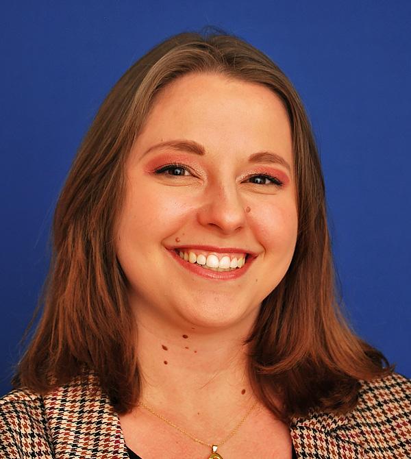 A headshot of Angel Jahnke. She has brown hair, brown eyes, and fair skin